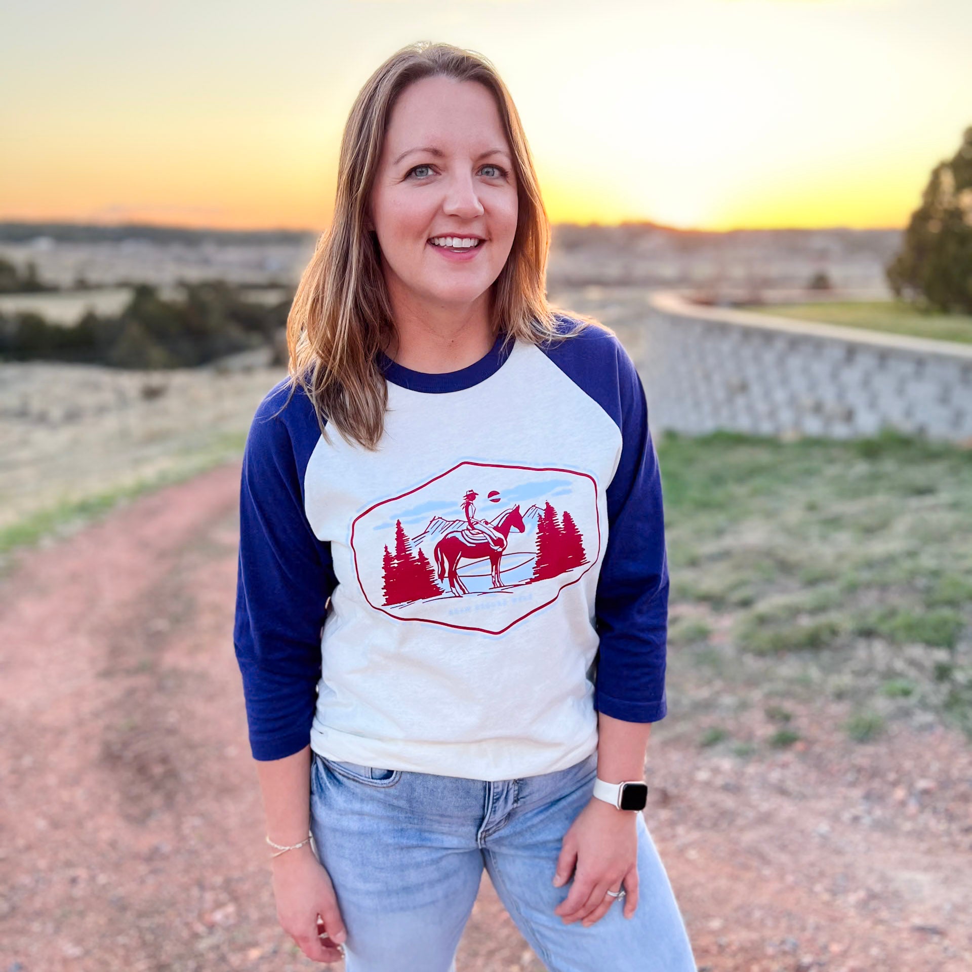 Americana cowgirl on horse tee. Baseball tee. Western americana tee. Roam Around Wear is a Wyoming t-shirt company based out of Gillette, Wyoming