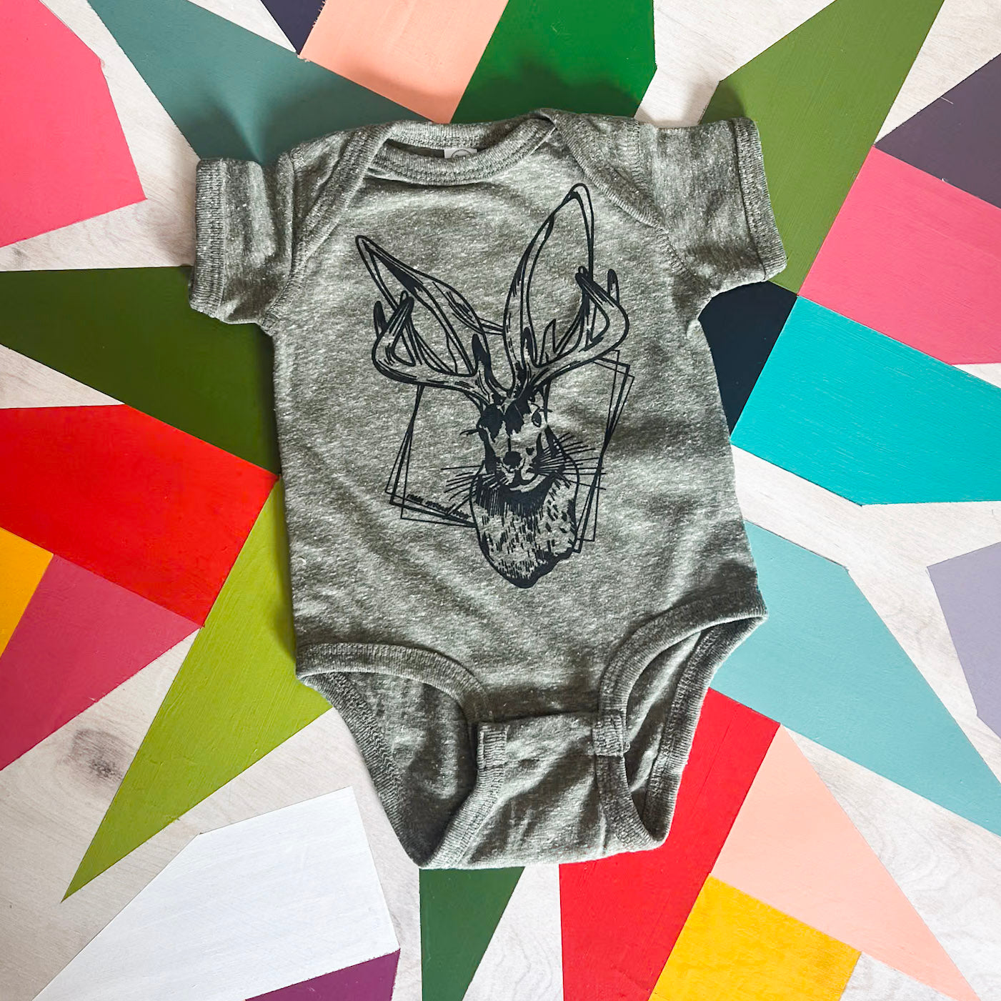 Black Jackalope Infant military green onesie. Roam Around Wear is a Wyoming t-shirt company based out of Gillette, Wyoming. Artisan Designed.