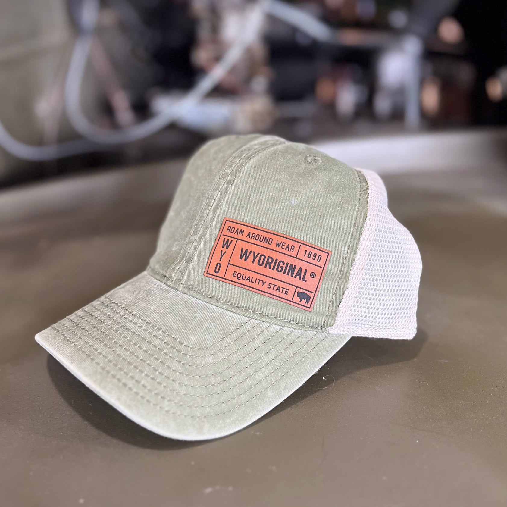 WYORIGINAL leather patch hat. Olive leather patch hat. Roam Around Wear is a Wyoming t-shirt company based in Gillette, Wyoming