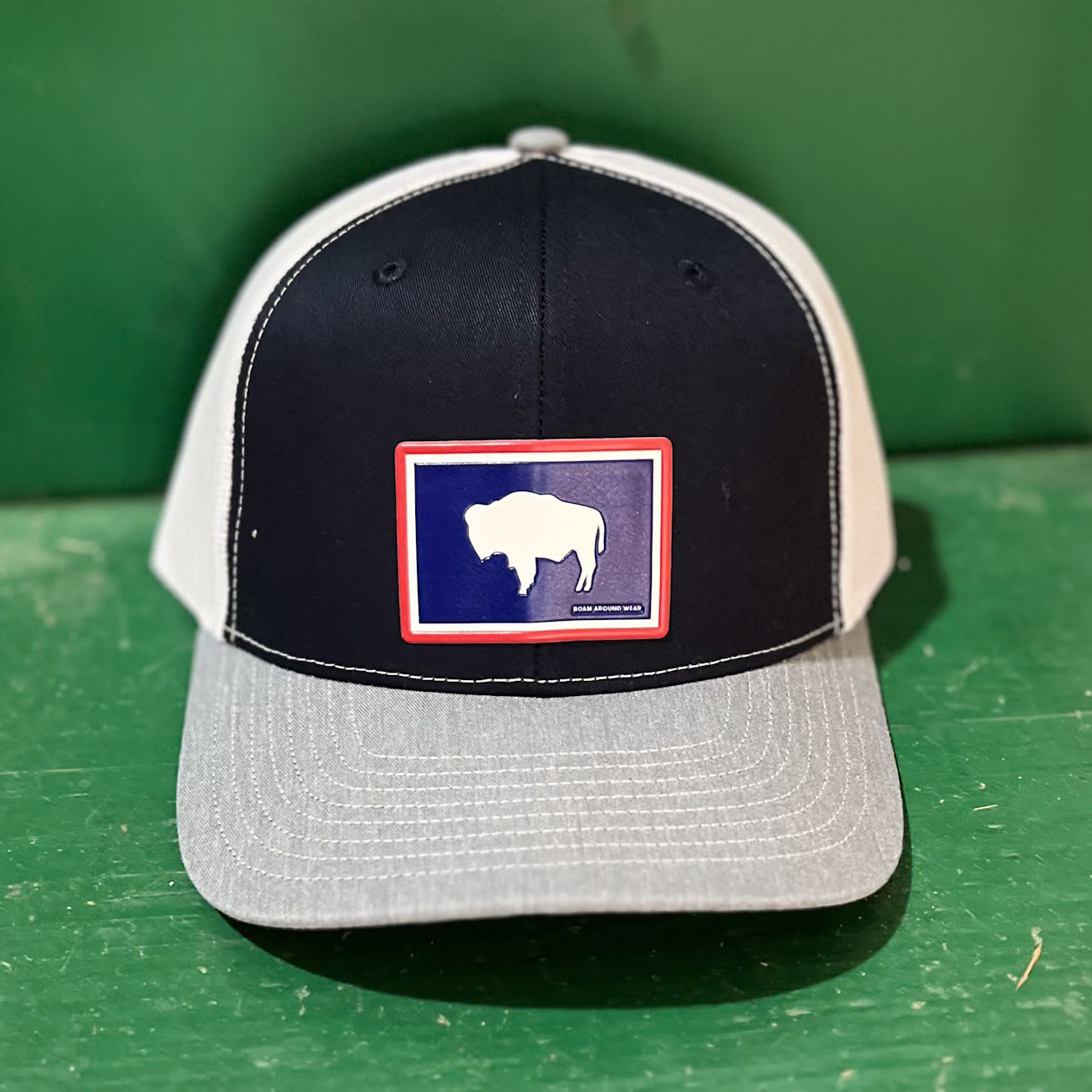 Navy/White/Grey snap back hat with Red/White/Blue buffalo patch adhered. Wyoming hat. Unisex fit. Roam Around Wear is a Wyoming t-shirt company based in Gillette, wyoming
