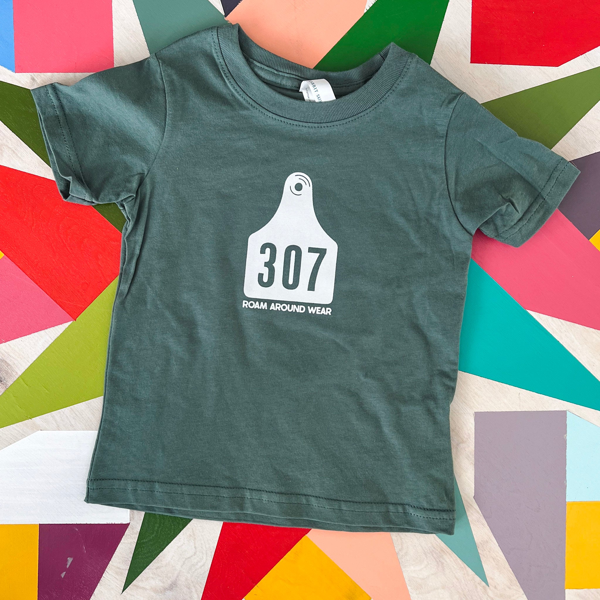 Green Toddler 307 Tee. Wyoming Cow Tag Toddler Shirt. Roam Around Wear is a Wyoming t-shirt company based out of Gillette, Wyoming