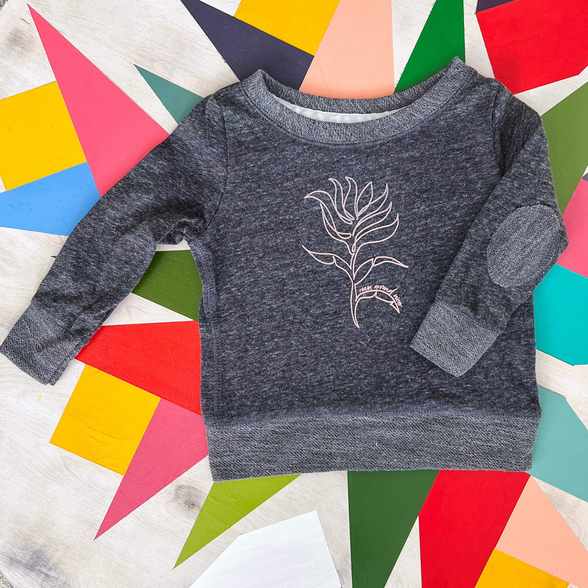 Pink Indian Paintbrush toddler and youth lightweight gray sweatshirt. Roam Around Wear is a Wyoming t-shirt company based out of Gillette, Wyoming. Artisan Designed. 