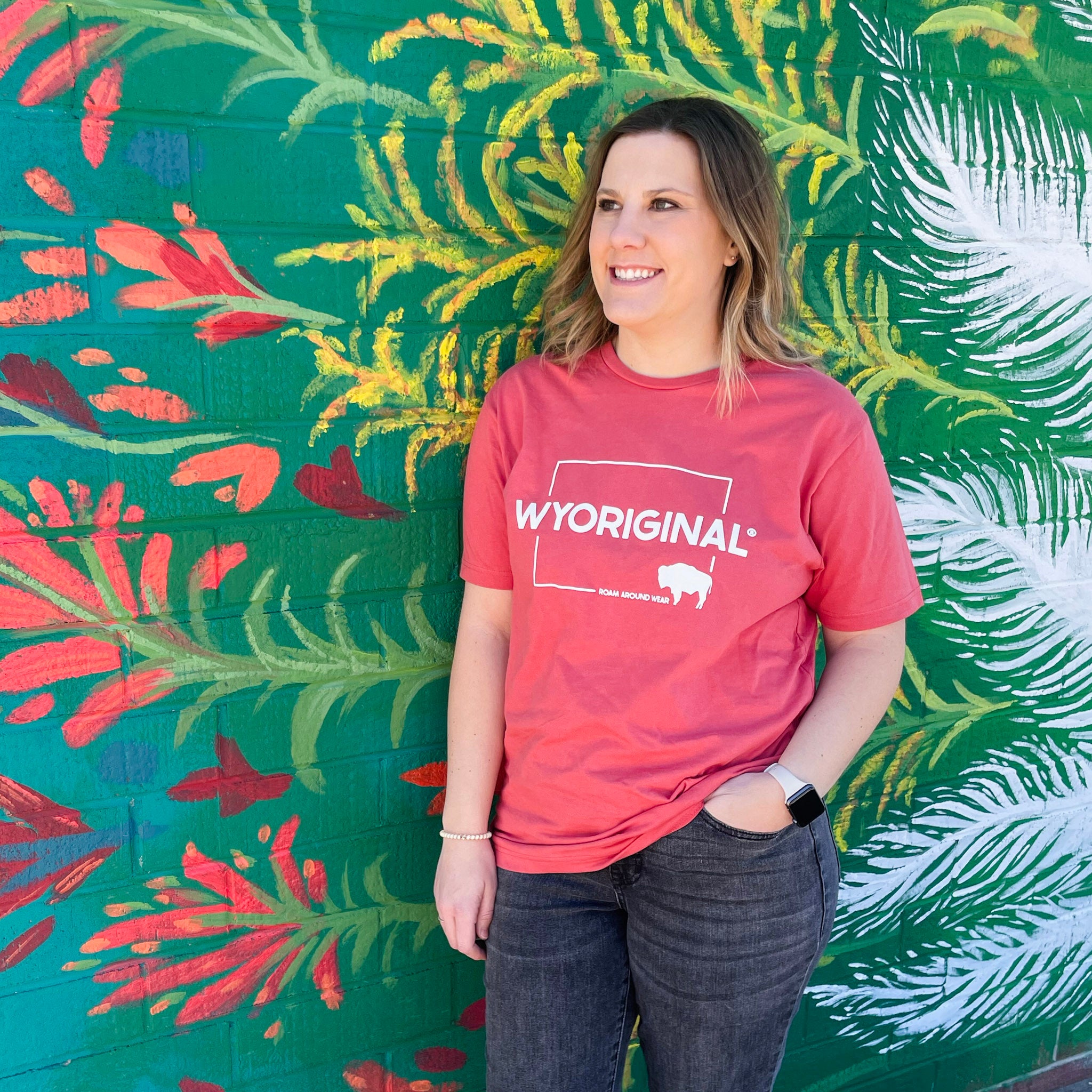 Wyoriginal Square State design in white on red/orange shirt. Roam Around Wear is a women owned Wyoming T-Shirt company based out of Gillette, Wyoming.