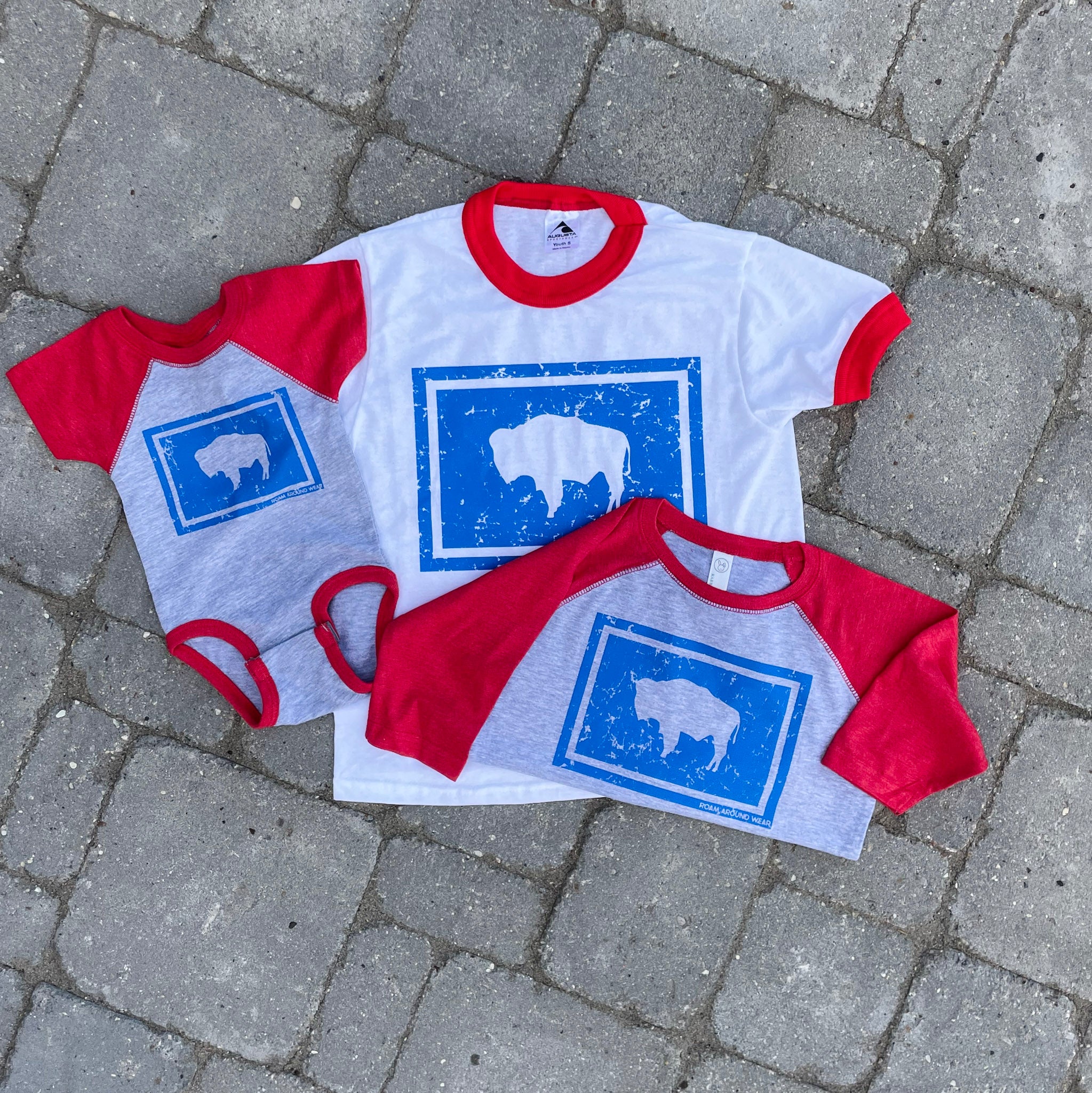 Wyoming flag toddler red, gray, blue tee. Roam Around Wear is a women owned Wyoming T-Shirt company based out of Gillette, Wyoming.