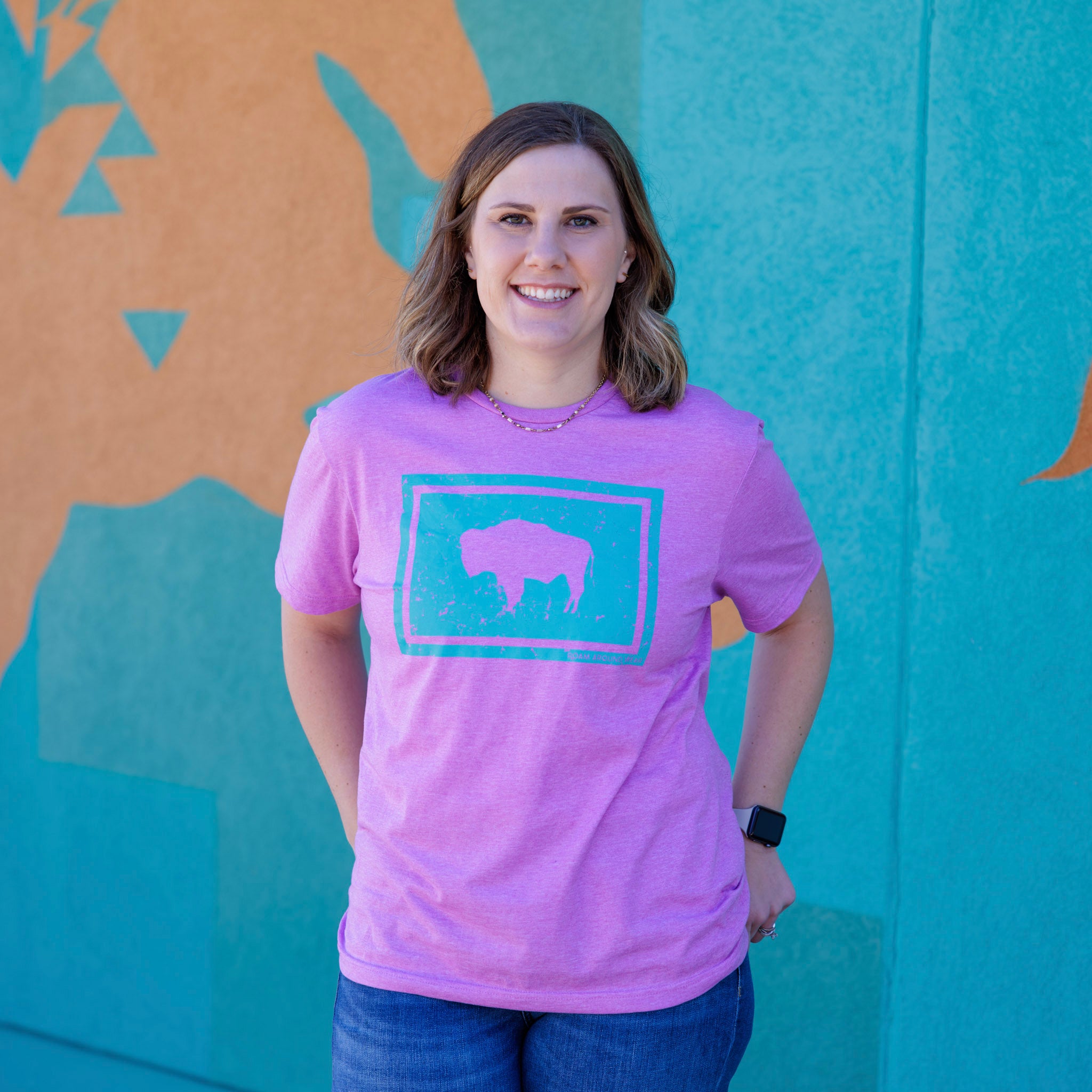Spring tee. Wyoming bison tee. Western bison t-shirt. Unisex tee. Women's pink tee with teal bison. Roam Around Wear is a Wyoming t-shirt company based in Gillette, Wyoming