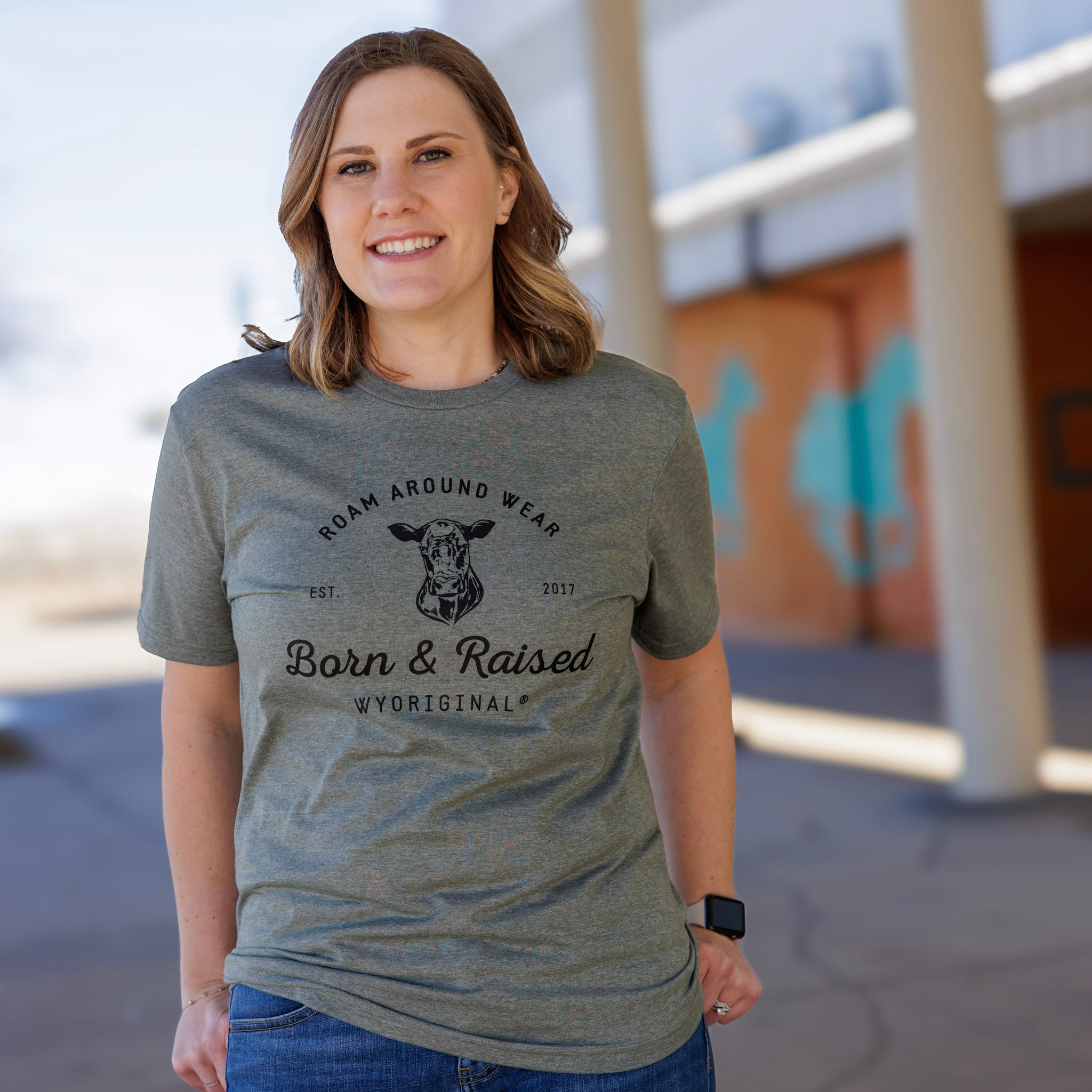 Wyoriginal Born and Raised cow tee. Unisex tee. Green wyoming tee. Ranch tee. Roam Around Wear is a Wyoming t-shirt company based in Gillette, Wyoming